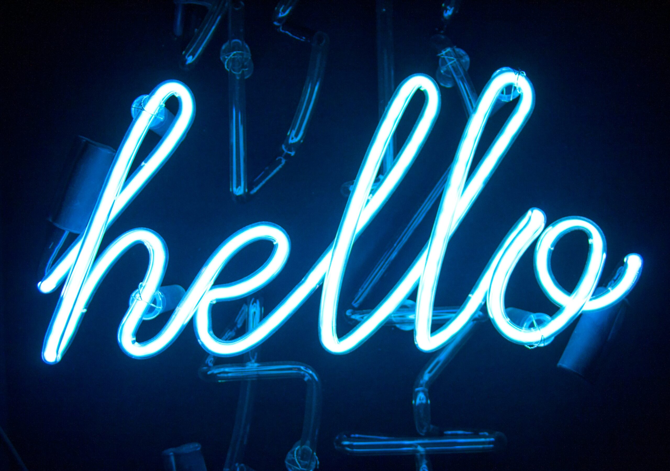 light blue neon light that reads "hello"